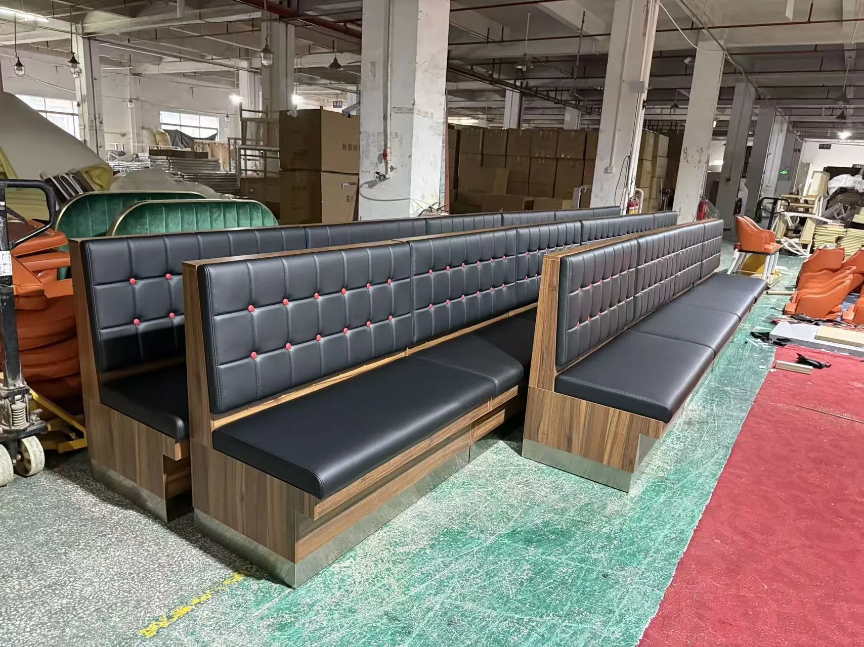 End view of a black restaurant booth showing the side panel and base