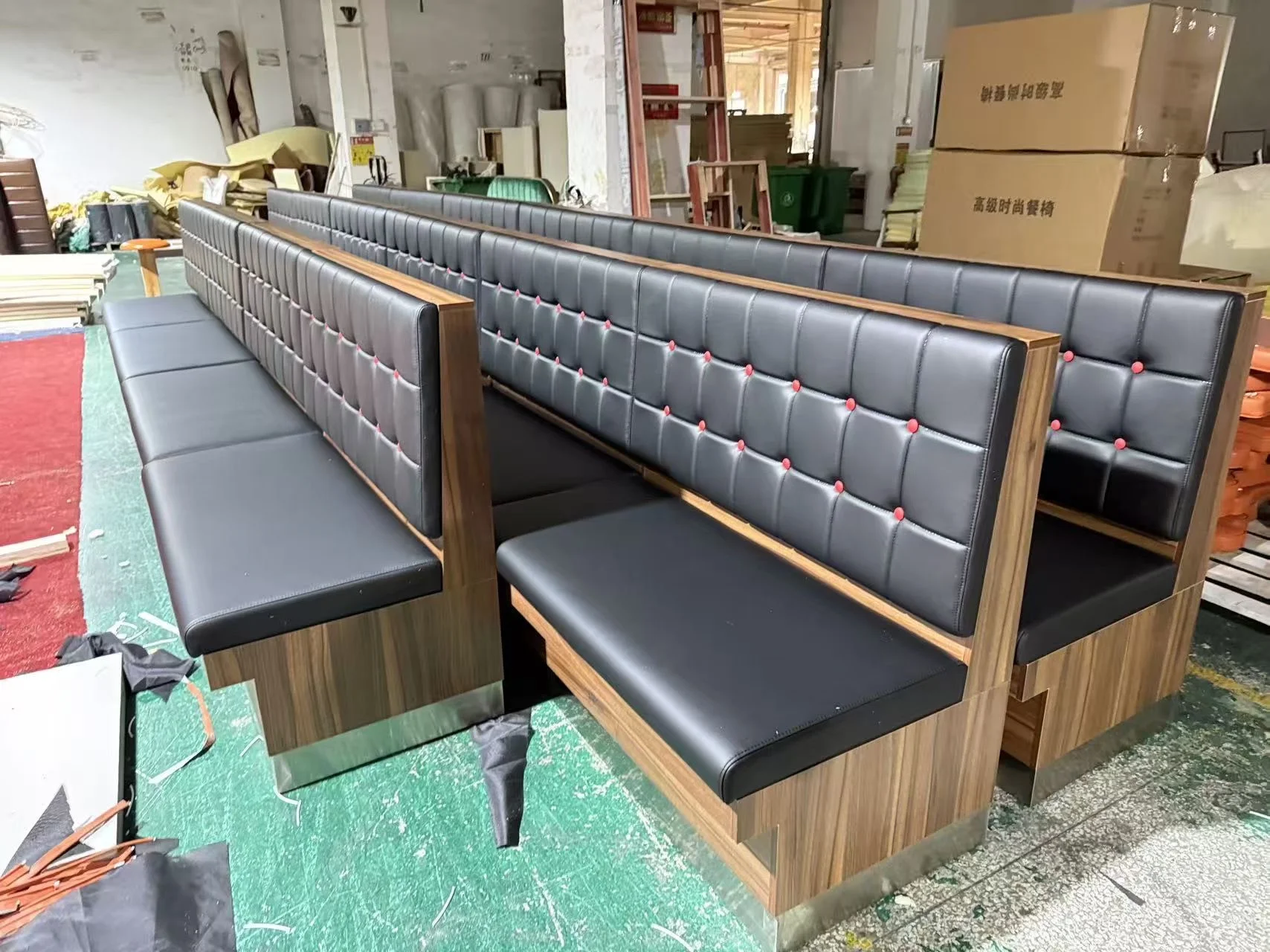 Black grid-back restaurant booth sections in the LONGG workshop