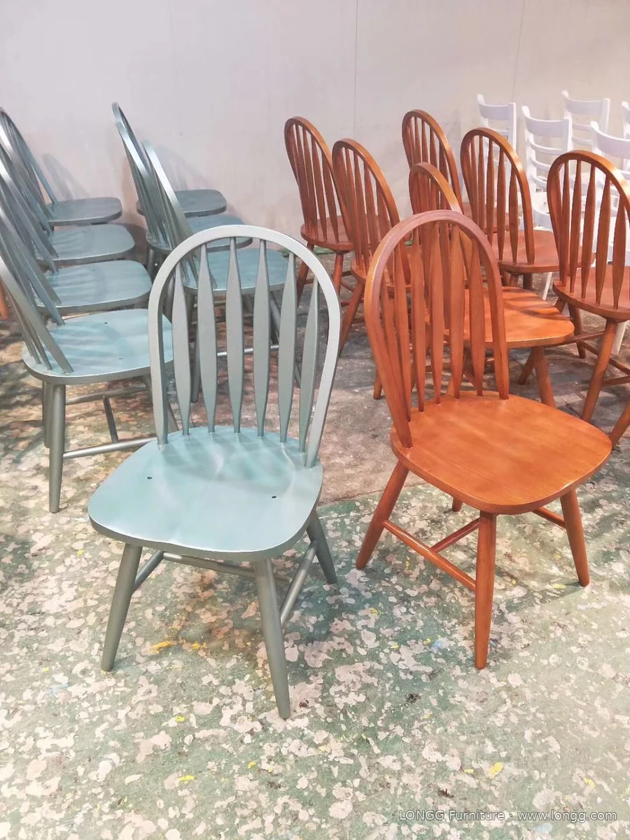 Curved-back dining chairs in green and warm wood-tone finishes