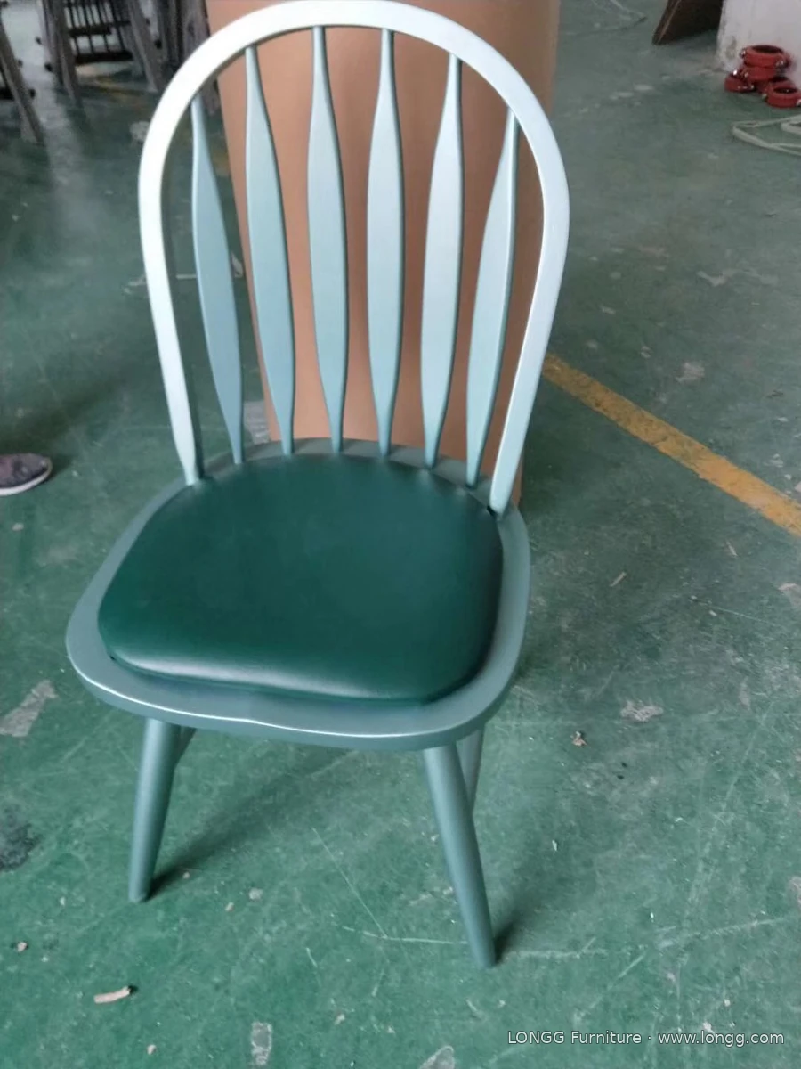 Green curved-back dining chair with an upholstered seat